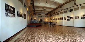Interior of a photo gallery with black and white photos exhibited on walls.