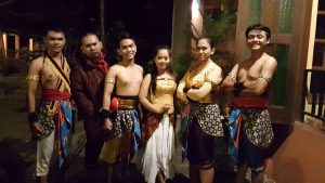 Group portrait shows Javanese dancers in traditional costumes.